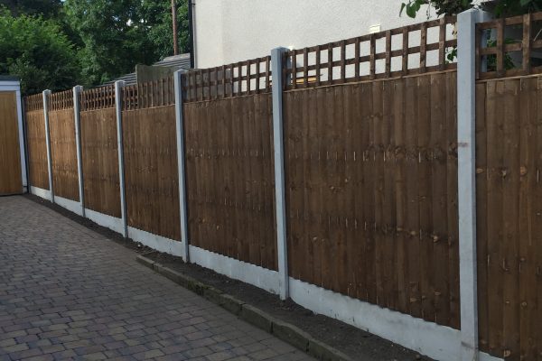 A long wooden fence. The fence has v type close board fence panels.