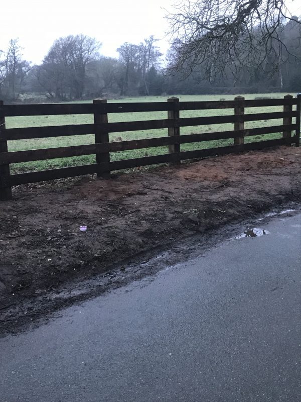 Pressure treated timber rail fence.