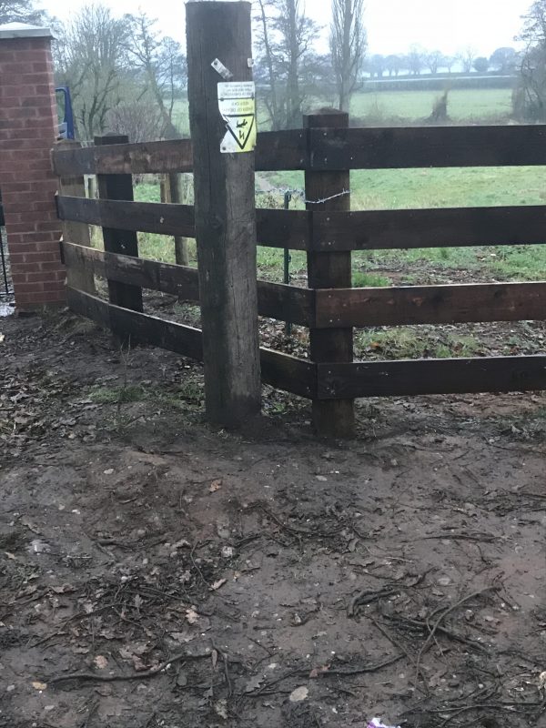 Pressure treated timber rail fence.