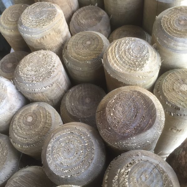 A collection of full round fence posts available for purchase at a fencing suppliers in Birmingham.