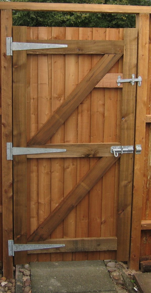 A gate frame holding a wooden garden gate. The gate had a steel tee hinge and lock.