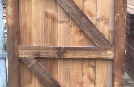 Garden gate held in place with wooden gate frames.