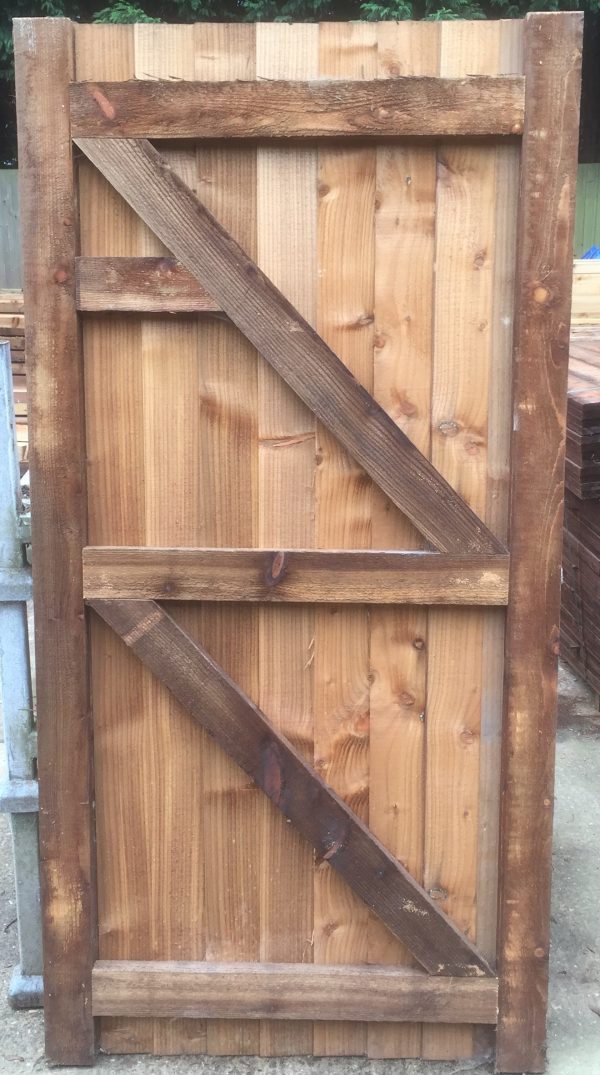 Garden gate held in place with wooden gate frames.