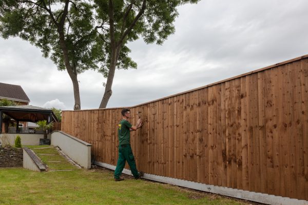 Hodges & Lawrence staff assembling a fence with feather edge boards.