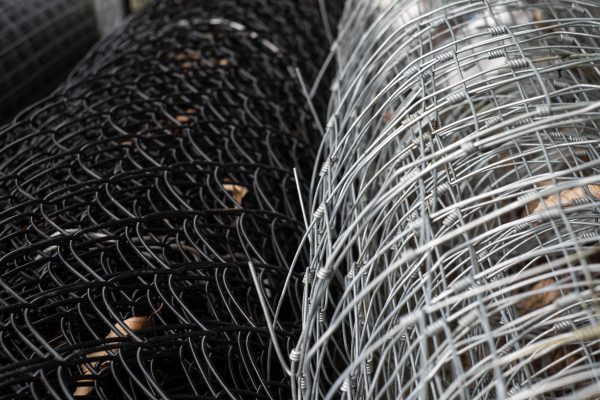 Two rolls of stock wire, one black and one silver. This stock wire can be used for fencing domestic or commercial properties