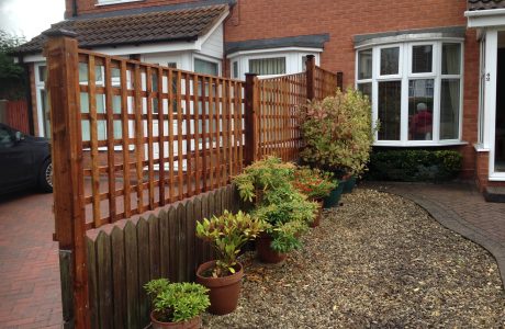 Wooden fencing. The fence has t type timber trellis panels.