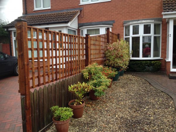 Wooden fencing. The fence has t type timber trellis panels.