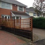 Wooden fence outside of a house in Birmingham. The fence has t type timber trellis fencing panels.