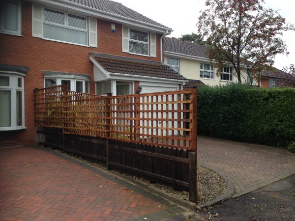 Wooden fence outside of a house in Birmingham. The fence has t type timber trellis fencing panels.