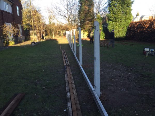 Hodges & Lawrence staff erecting concrete fence posts.