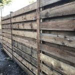 Pressure treated timber rails on display in a fencing suppliers in Birmingham.