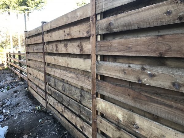 Pressure treated timber rails on display in a fencing suppliers in Birmingham.