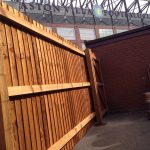 A wooden commercial fence surrounding a yard in Birmingham .