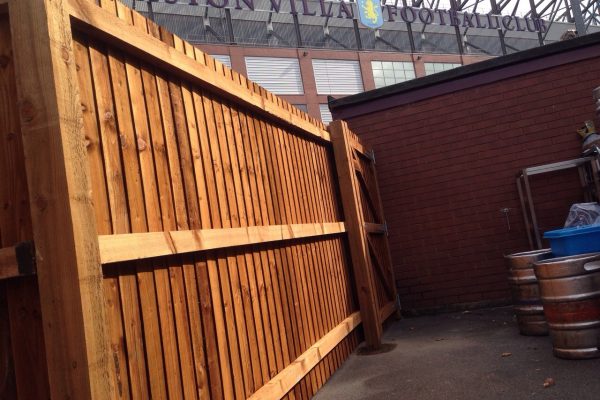 A wooden commercial fence surrounding a yard in Birmingham .