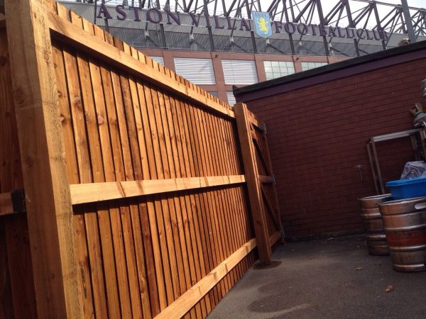 A wooden commercial fence surrounding a yard in Birmingham .