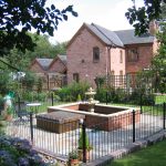 Black bespoke railings used in a garden in Birmingham.