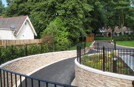 A driveway in Birmingham with bespoke commercial fencing on either side.