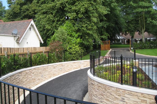 A driveway in Birmingham with bespoke commercial fencing on either side.