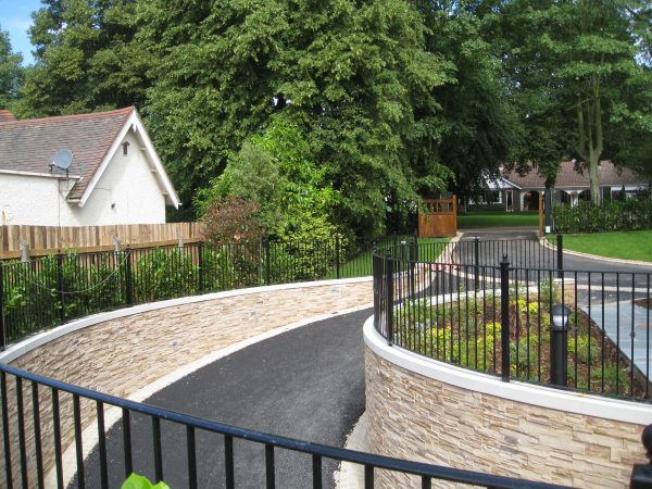 A driveway in Birmingham with bespoke commercial fencing on either side.